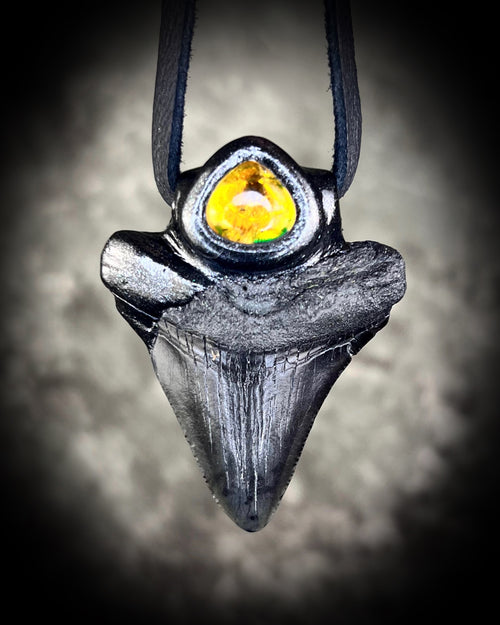 Statement black megalodon fossil tooth handmade into a stunning necklace, crystal talisman featuring citrine gemstone, with black leather for a witchy unisex appeal. 