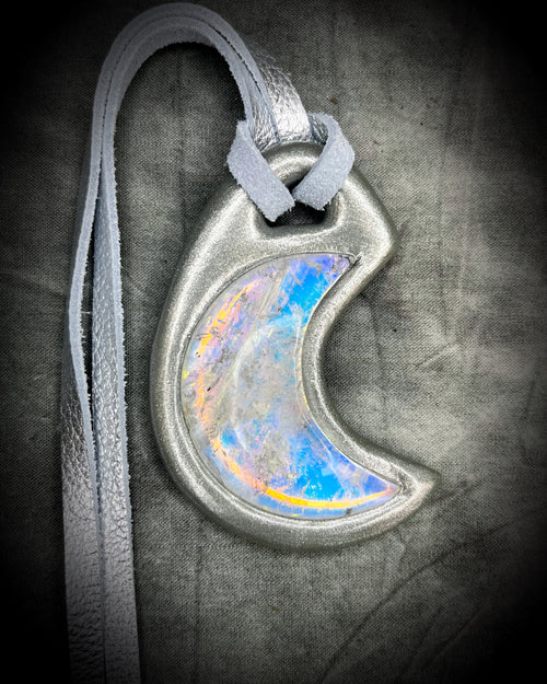 Handcrafted designer opalescent quartz gemstone crescent moon pendant in a silver finish.  This crystal healing necklace is strung from silver leather for eco-friendly bridal or bridesmaid jewelry.