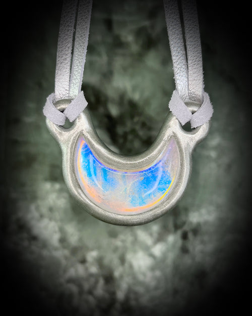 Handmade designer opalescent quartz gemstone crescent moon pendant in a silver finish.  This crystal healing necklace is strung from silver leather for the eco-friendly moon lover and jewelry collector.  