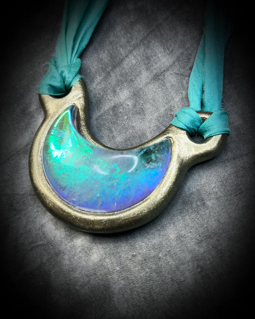 Handmade designer opalescent quartz gemstone crescent moon pendant in a gold finish.  This crystal healing necklace is strung from recycled silk for the eco-friendly jewelry collector. 